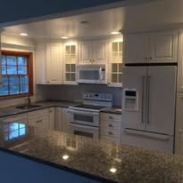 Kitchen remodel with white cabinets and granite countertops