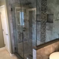 Bathroom shower with stone tile and glass enclosure