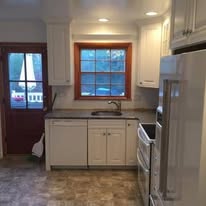Kitchen remodel with white cabinets and tile floor