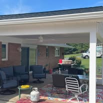 Covered porch addition with ceiling fan and outdoor furniture