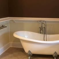 Bathroom with clawfoot tub and wainscoting