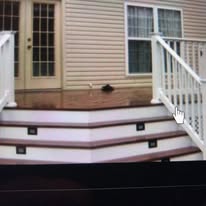 Composite deck with white railing and step lighting