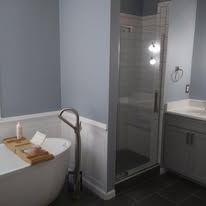 Bathroom remodel with freestanding tub and frameless glass shower