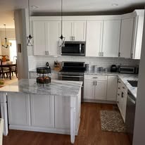 Kitchen remodel with white shaker cabinets and granite island