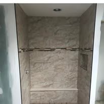 Frameless glass shower with large format marble tile
