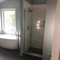 Bathroom with freestanding tub and frameless glass shower
