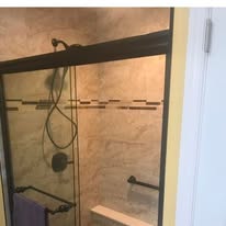 Bathroom shower with glass sliding door and tile