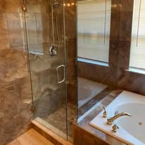Bathroom with glass shower enclosure and jetted soaking tub