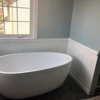 Bathroom with freestanding soaking tub and wainscoting