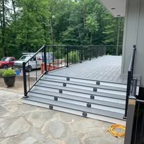 Composite deck with steps and black metal railing