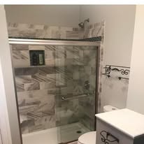 Bathroom shower remodel with sliding glass door and tile