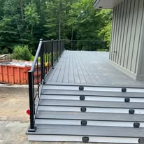 Gray composite deck with steps and black metal railing